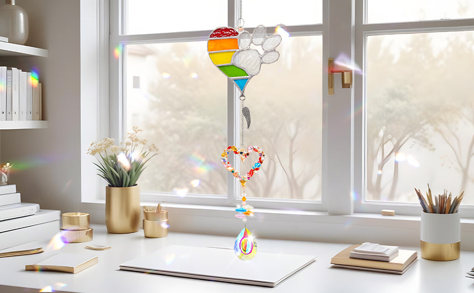 suncatcher metal rainbow paw and heart-shaped rainbow pendant and teardrop crystal pendant hang on the table under the sunshine